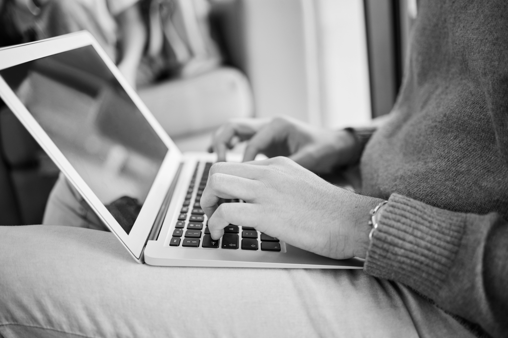 Hands typing on a computer